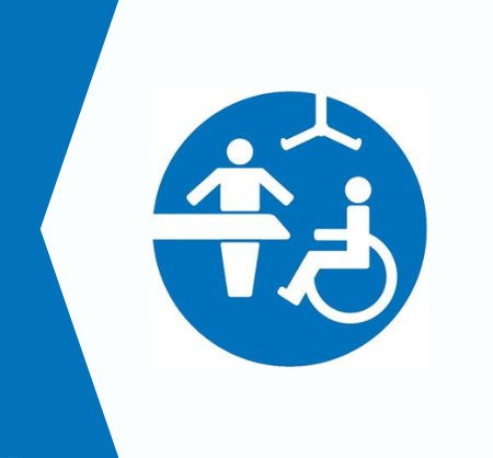 Icon showing a person, a changing bench, a hoist, and a person in a wheelchair, symbolising an accessible Changing Places toilet facility.